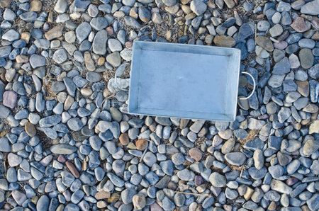 A metal pan on a pebble footpath.の写真素材