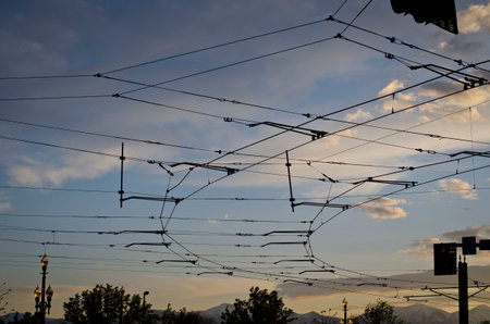 A sky of street car wires in the cool calm sunset of the salt lake city sky.の写真素材