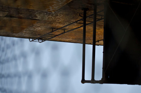Looking at the side view of the fire escape through the chain linked fence.
