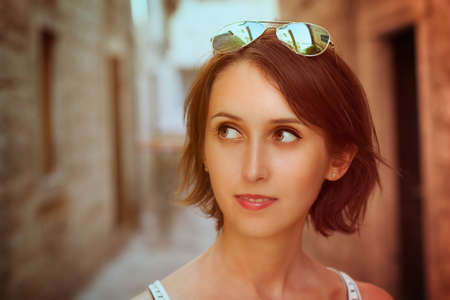 Toned Portrait of Trendy Young Woman with Bob Hairstyle in the Old Street  Filtered Photo with Shallow Depth of Field の写真素材