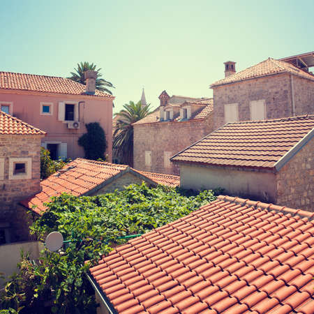 View of Red Tiled Roofs of Medieval Mediterranean Town. Retro Background. の写真素材