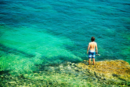Young Man with Diving Mask Standing in Clear Sea  Healthy Lifestyle Concept  Summer Vacation  Copy Space の写真素材
