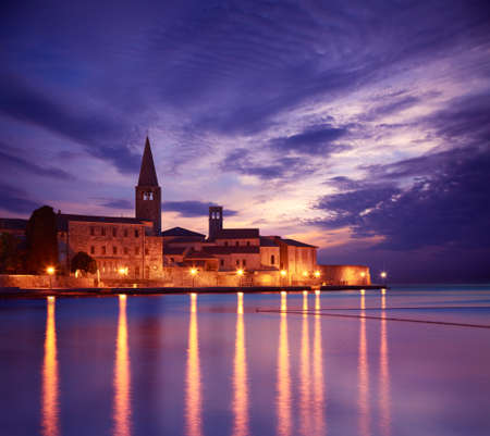 Porec View at Sunset. Medieval Mediterranean City in Croatia. Popular Tourist Resort of Istria at Adriatic Sea. Copy Space. Toned Photo.の写真素材