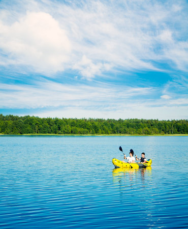 Two Men Paddle a Kayak on Lake. Healthy Lifestyle Concept.の写真素材