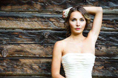Young Bride Portrait on Wooden Background. Modern Wedding Hairstyle. Copy Space.の写真素材
