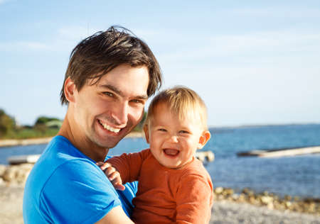 Happy Father with His Little Son at the Sea. Family Love Concept. Toned Photo with Copy Space.の写真素材