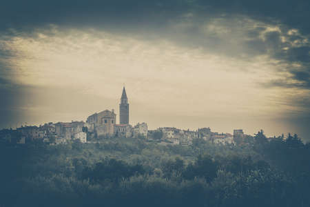 Buje Old Town View. Medieval Mediterranean City in Istria, Croatia. Balkan, Europe. Toned and Filtered Vintage Styled Photo with Copy Space.の写真素材