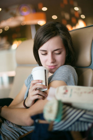 girl sitting wait airport coffee travel beautifulの写真素材