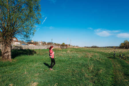 girl travel bicycle backpack forest redhead villageの写真素材