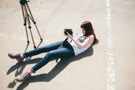 photographer shooting land asphalt tripod lie upの写真素材