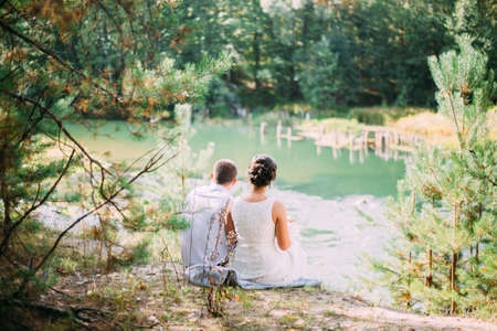 river wedding couple sit together forest loveの写真素材