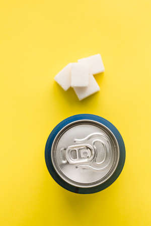 Bank of soda and sugar cubes on a bright backgroundの写真素材