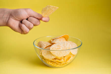 plate of chips unhealthy food on blue color backgroundの写真素材