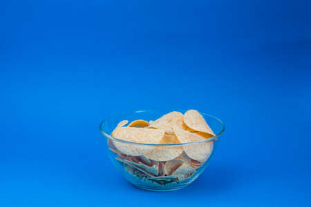 plate of chips unhealthy food on blue color backgroundの写真素材