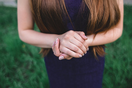 her clasped hands girls nature background green purpleの写真素材