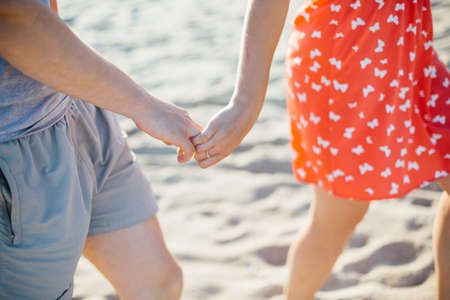 couple holding hands in beach summer love warmの写真素材