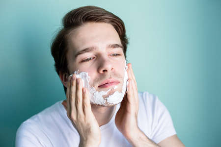 The man is shaving. Morning procedures. Morning of a young man.の写真素材