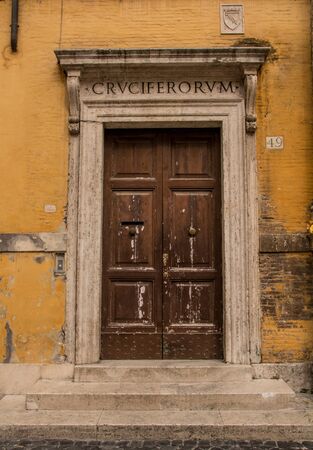 Historic doorway in stone building with Roman lettering above the doorの写真素材