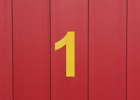 the number one yellow set against bright red woodの写真素材