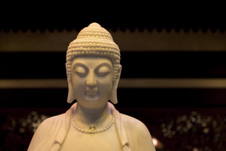 Head and shoulders of the Buddah, in mock ivory materialの写真素材