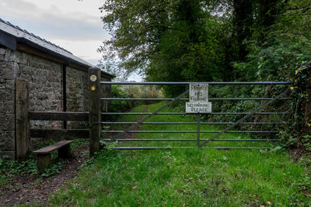 A metal gate on a country path, with a sign attached that says 'Private, no fishing or parking'の写真素材