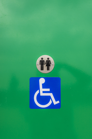 Disabled toilet sign, against a green backgroundの写真素材