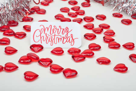 Red Hearts and Silver Garland With Merry Christmas Cardの写真素材