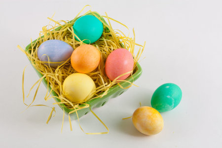 Multicolored Easter Eggs in Green Crate With Yellow Grass