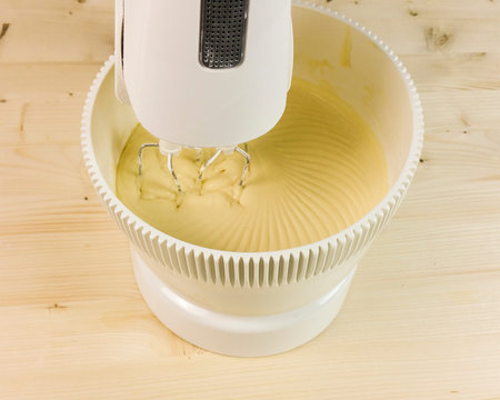 mixing the cream on wood backgroundの写真素材