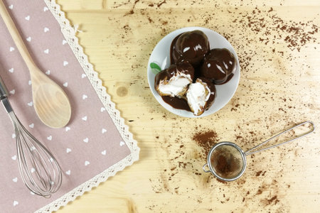 Profiteroles on wood background - top view