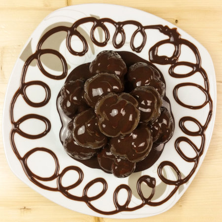 Profiteroles on wood background - top view