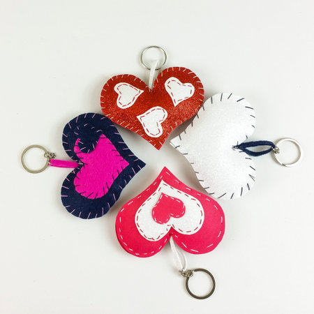 Homemade valentine's red heart and paper boxes on white background -  top view