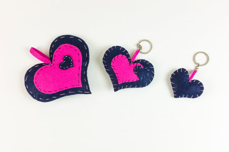 Homemade valentine's red heart and paper boxes on white background -  top view