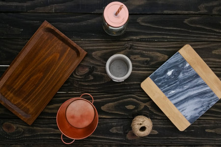 various types of trays and containers on wooden background - top view
