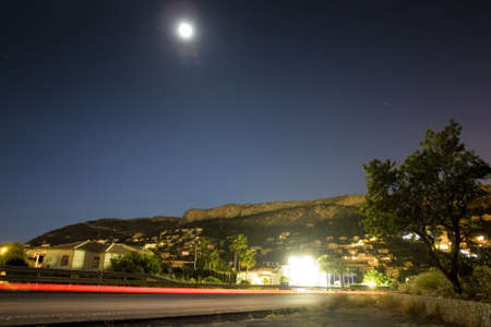 long exposure shot at nighttime beside the road in the mountainsの写真素材