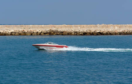 speedy rapid little boat passing byの写真素材