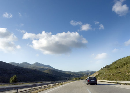 hilly landscape of Spain, with light traffic on highwayの写真素材