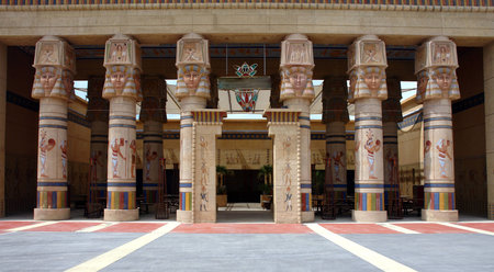 open entrance with illustrated pillars and egyptian style paintings