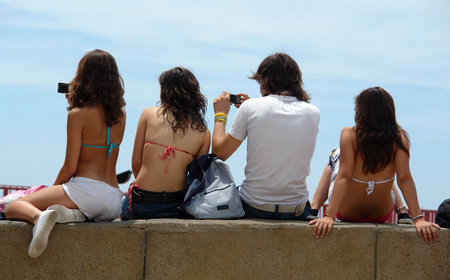 young people having good time in the sun while taking snapshots with digital camerasの写真素材