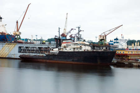Old Black Rusty Transportation Ship Dockingの写真素材
