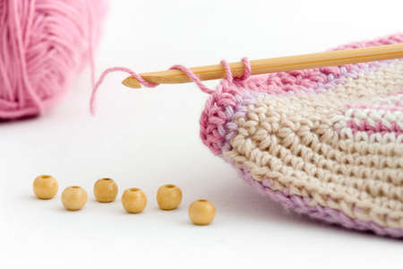 Details of crochet - bamboo  needle in focus, also pattern and wooden pearlsの写真素材