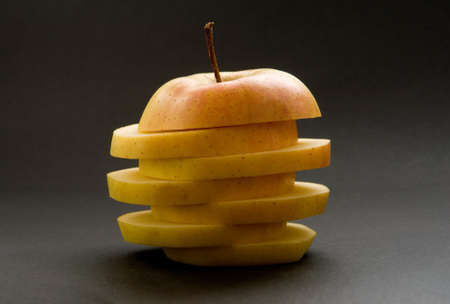 Slices of resh yellow apple on each other.の写真素材