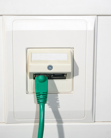 a green network cable on the wallの写真素材