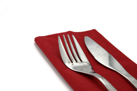 a fork and a knife on a red napkinの写真素材