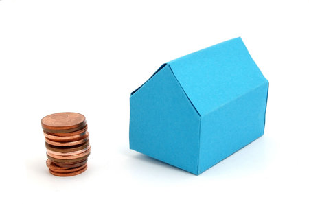 a blue paper house with some coinsの写真素材