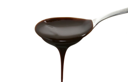 chocolate syrup on a spoonの写真素材