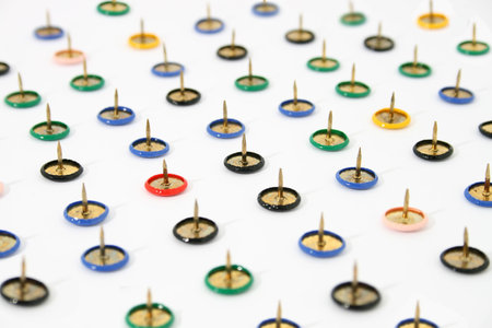 pushpins arranged on a white background