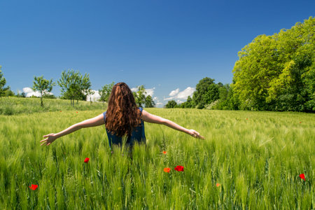 Girl in the field, enjoying the moment.の写真素材