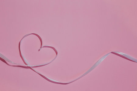 Happy Valentine's Day. Pink ribbon heart on a pink background. Valentine's day concept.の写真素材