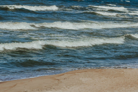 Waves on the Baltic Sea in Klaipeda in spring. The concept of tourism in Europe.